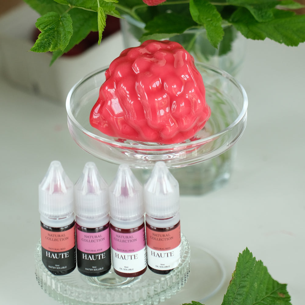 Set of Haute liquid-gel food color bottles with a raspberry realistic dessert and green leaves in the background. Best Natural Haute Food Colors by Ksenia Penkina, Vegetable Colours, Liquid Gel, Water Soluble, Oil Soluble, Fat Soluble Gel, Food Colouring, Chefrubber, Colourmill, Chefmaster, Silikomart, Pavoni, Decorelief, Matfer, PastryClass, Valrhona, Cacao Barry, For Macarons, For Glazing